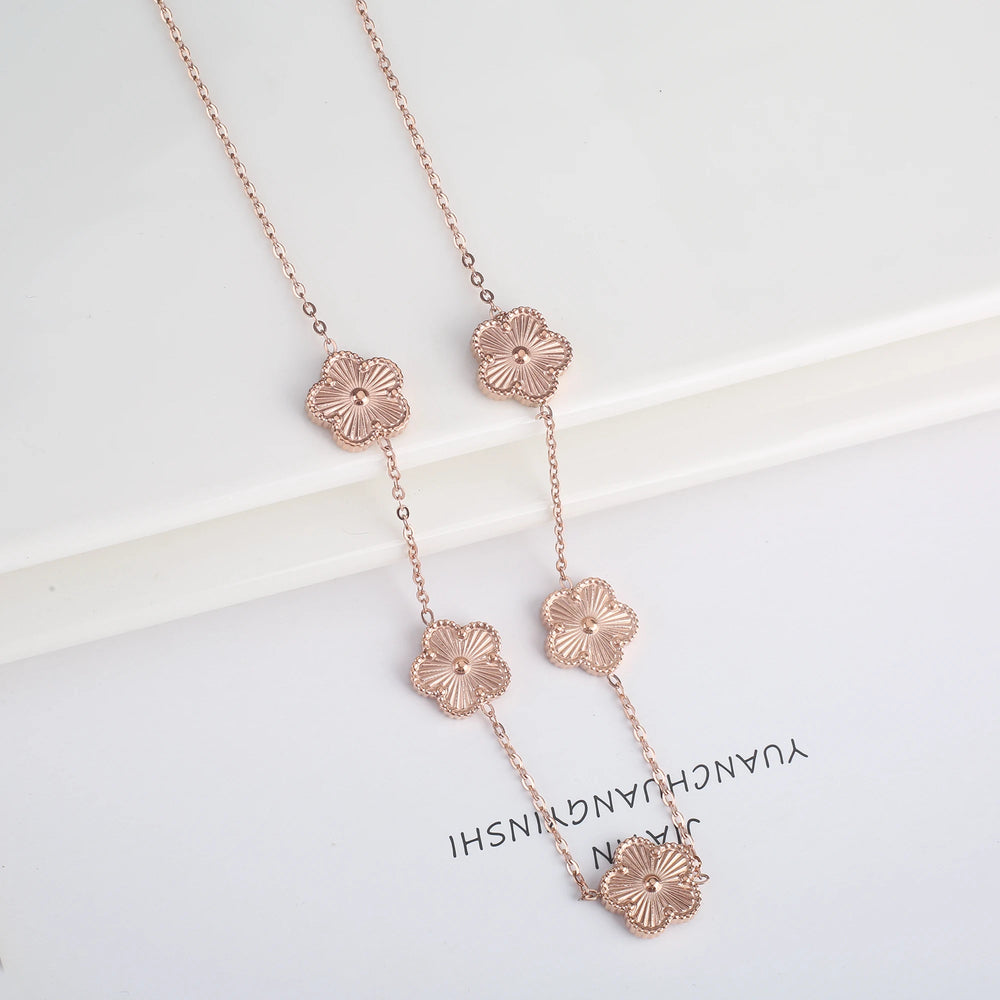 Stainless steel clover bracelet with four leaf charm design
