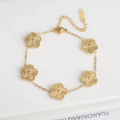 Stainless steel clover bracelet with four leaf charm design
