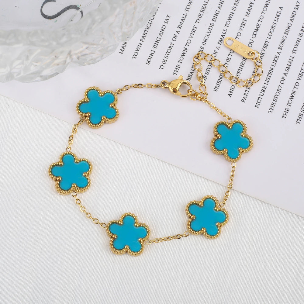Stainless steel clover bracelet with four leaf charm design
