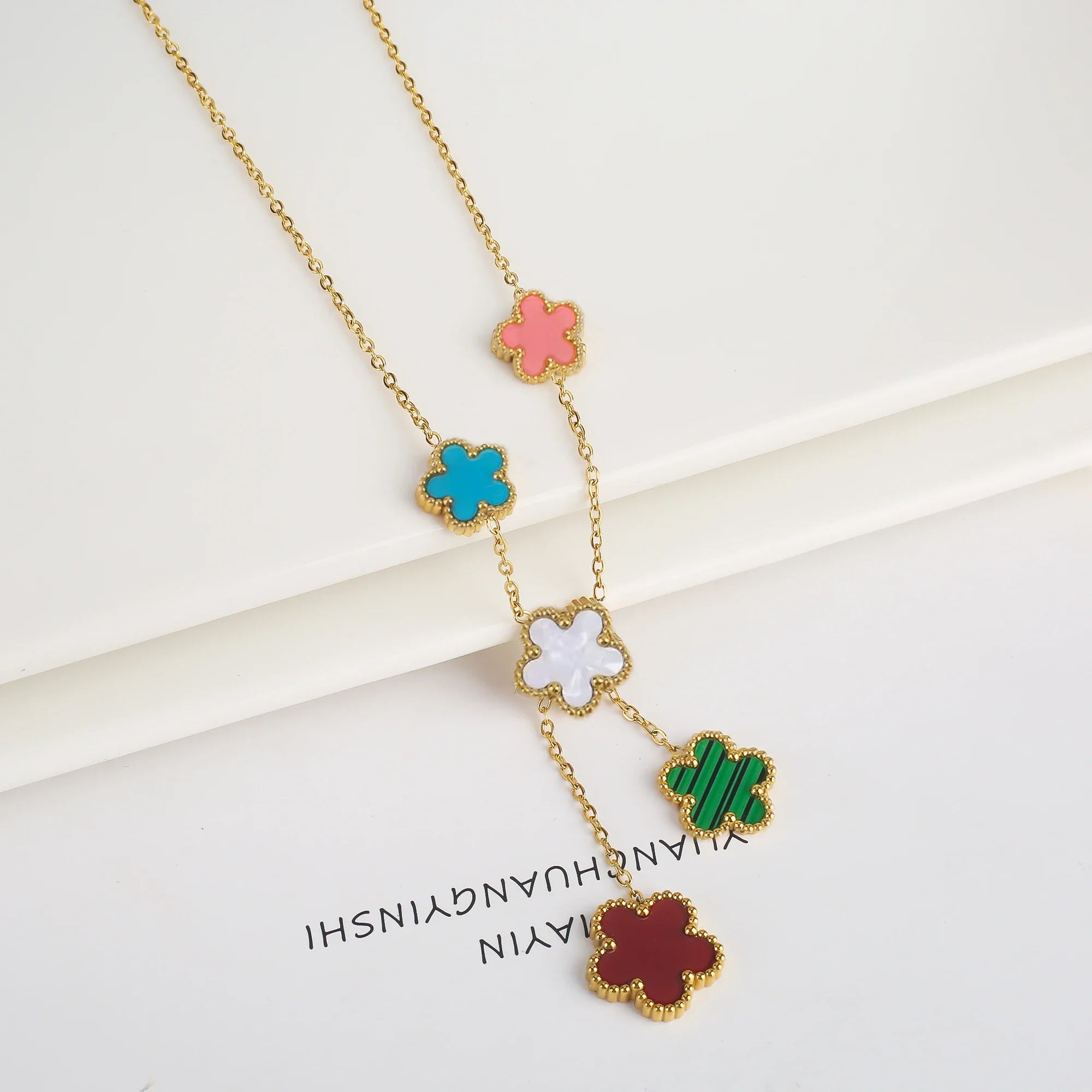 Stainless steel clover bracelet with four leaf charm design
